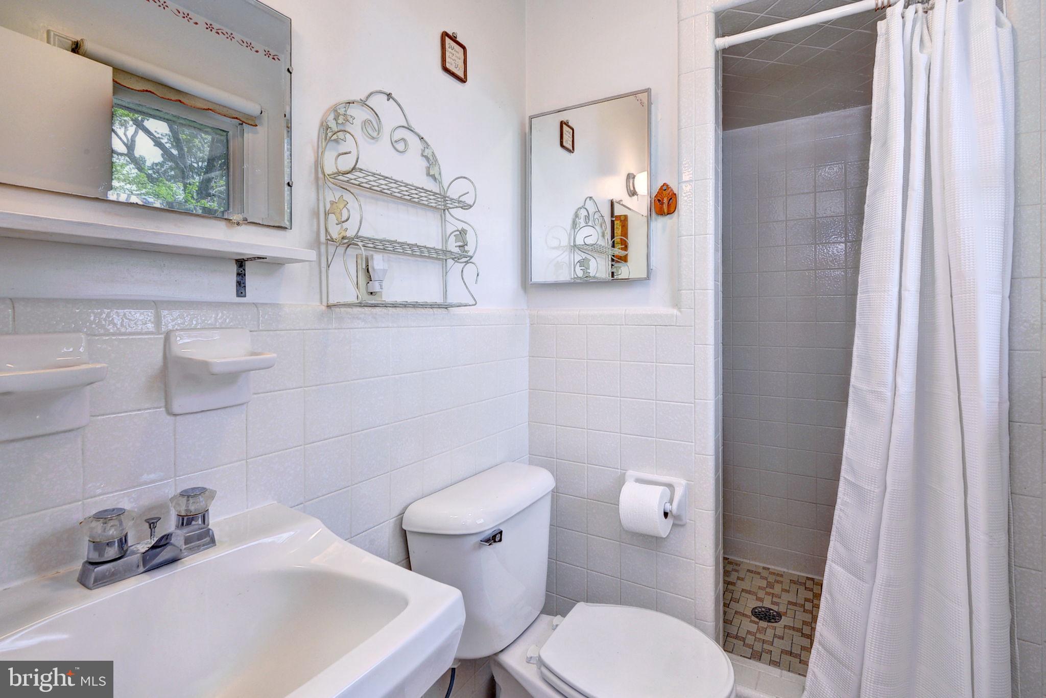 5556 Roanes Wharf Road Gloucester, VA 23061 - Photo 20 of 84 a white toilet sitting next to a bathroom sink