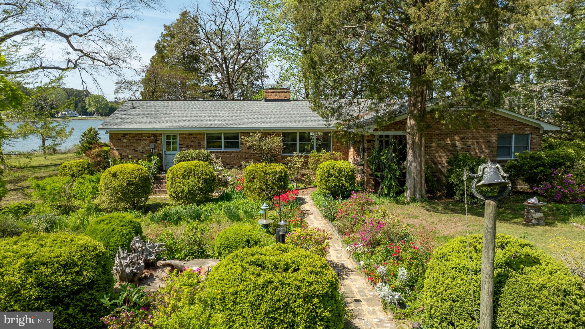 5556 Roanes Wharf Road Gloucester, VA 23061 - Photo 2 of 84 a view of a house with a flower garden