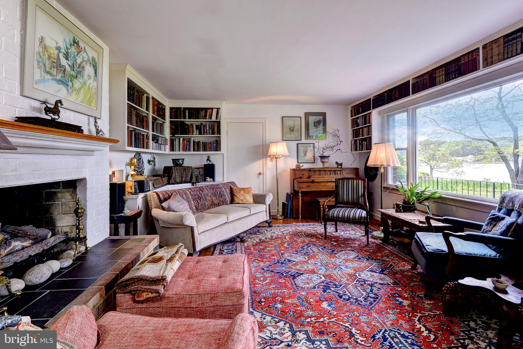 5556 Roanes Wharf Road Gloucester, VA 23061 - Photo 25 of 84 a living room with furniture fireplace and a large window