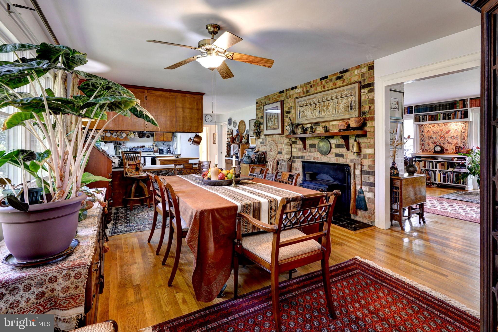 5556 Roanes Wharf Road Gloucester, VA 23061 - Photo 30 of 84 a dining room with a table chairs and a fireplace