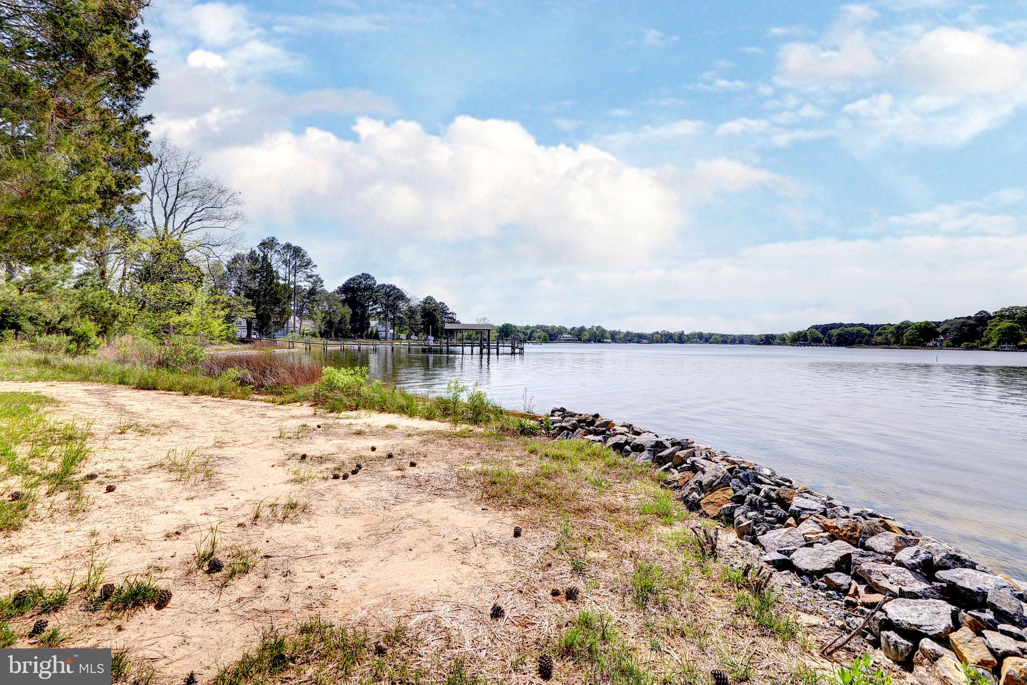 5556 Roanes Wharf Road Gloucester, VA 23061 - Photo 51 of 84 a view of a lake with houses in the background
