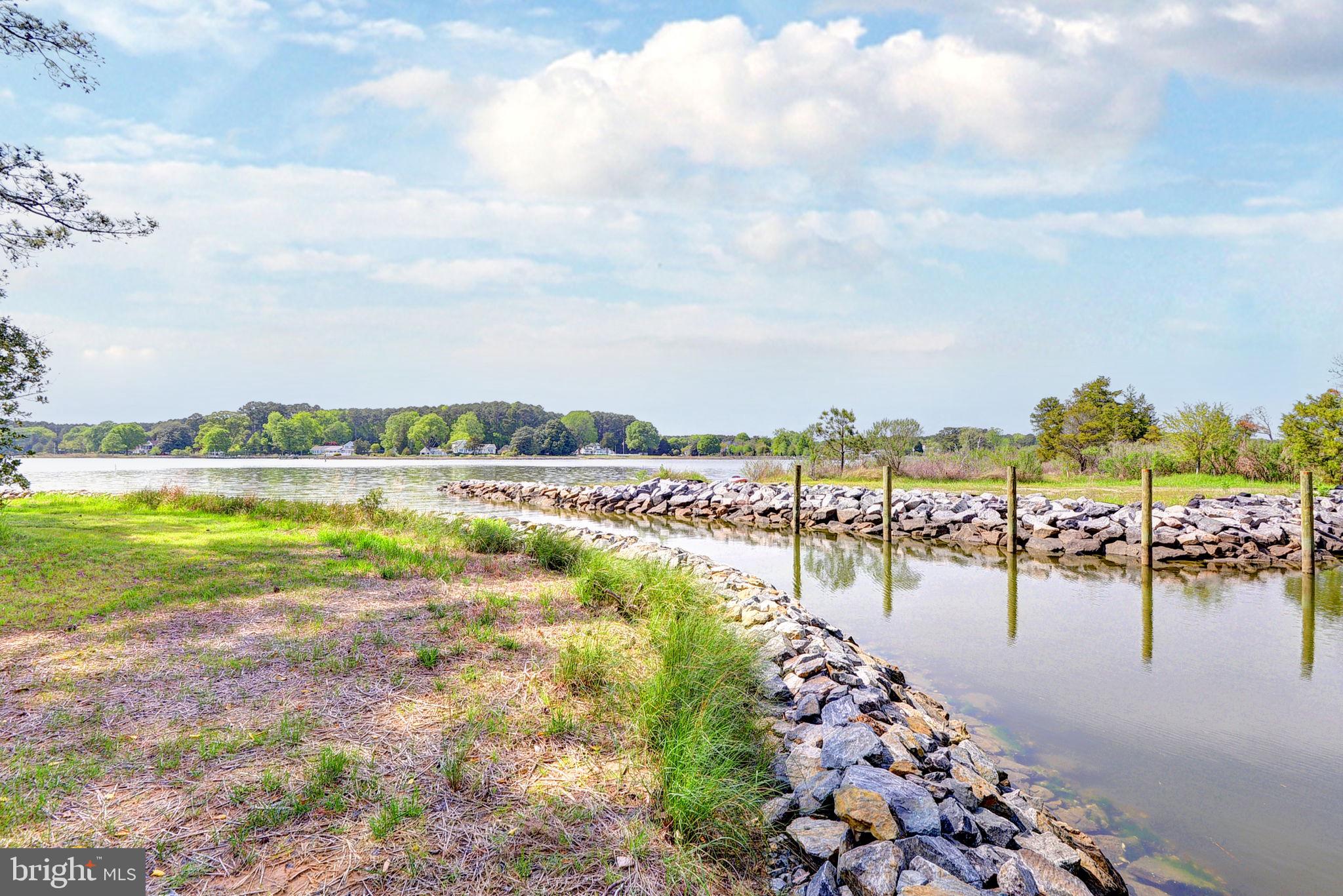 5556 Roanes Wharf Road Gloucester, VA 23061 - Photo 52 of 84 a view of a lake with houses in the back