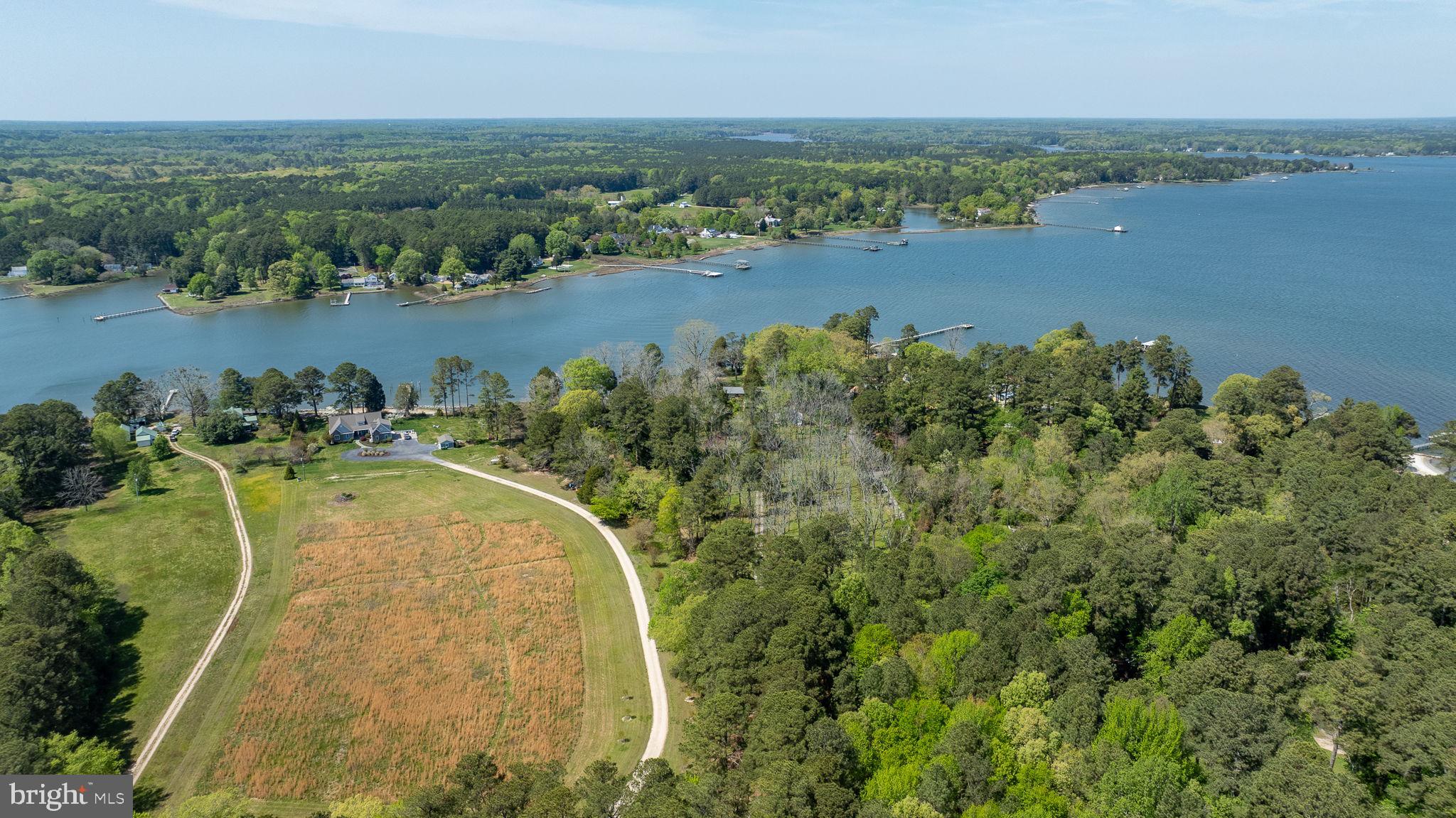 5556 Roanes Wharf Road Gloucester, VA 23061 - Photo 67 of 84 an aerial view of a residential houses with outdoor space and lake view in back