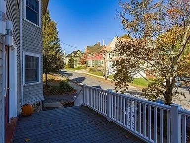 a view of balcony with wooden floor and outdoor seating