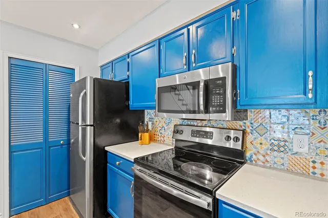 a kitchen with stainless steel appliances granite countertop a stove microwave and refrigerator