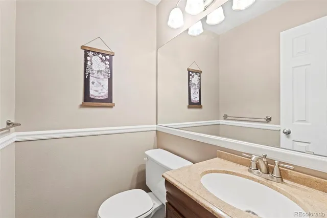 a bathroom with a sink mirror and toilet