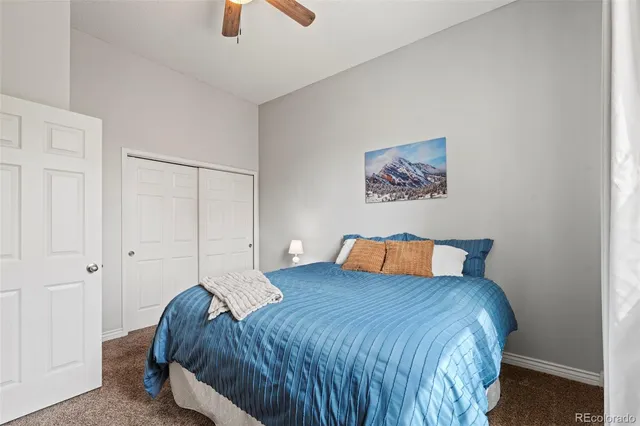 a bedroom with a bed and painting on the wall