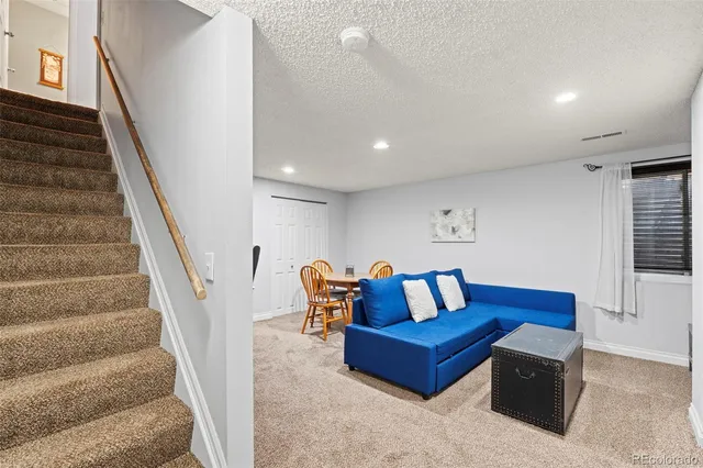 a bedroom with furniture and stairs