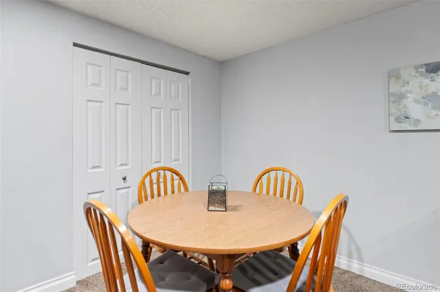 a view of a dining room with furniture and a window