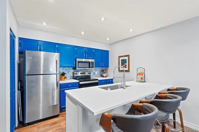 a kitchen with a refrigerator a stove a sink and a refrigerator