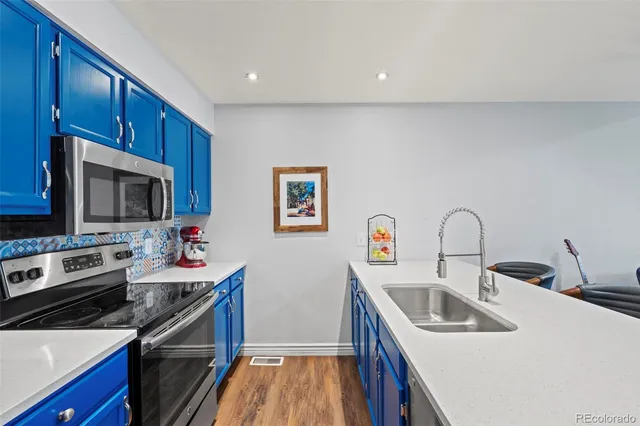 a kitchen that has a sink and a stove top oven
