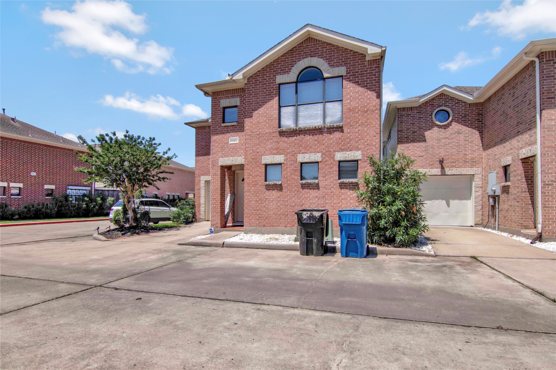 5951 S Loop East, Unit 4 Houston, TX 77033 - Photo 2 of 26 a front view of a house with a yard and garage