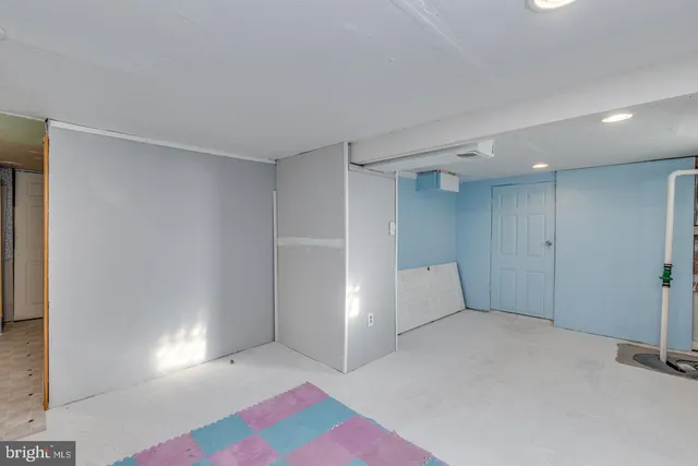 a spacious bathroom with a granite countertop sink and a toilet