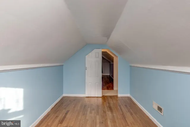 a view of a room with wooden floor and natural light