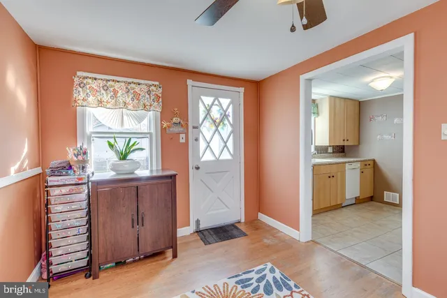 a view of a kitchen with a sink and dishwasher with wooden floor