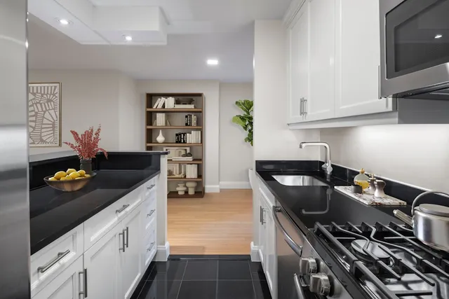 a kitchen with stainless steel appliances granite countertop a stove a refrigerator and a counter space