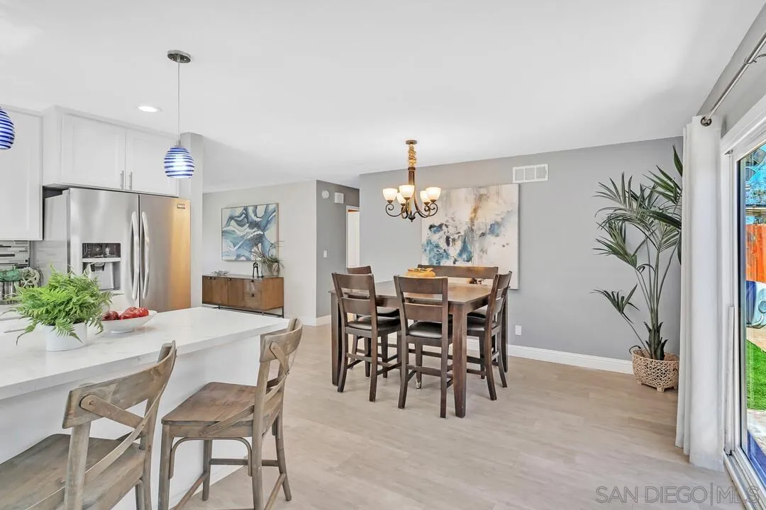 11021 Sagittarius Road San Diego, CA 92126 - Photo 11 of 28 a view of a dining room with furniture and chandelier
