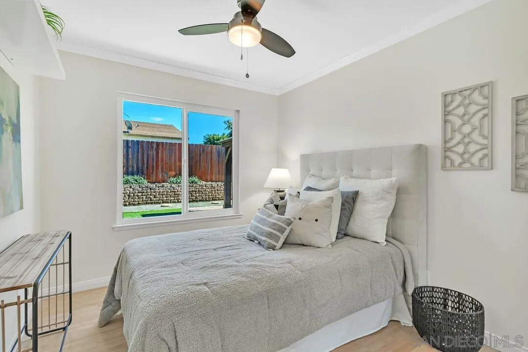 11021 Sagittarius Road San Diego, CA 92126 - Photo 19 of 28 a bedroom with a large bed and a window
