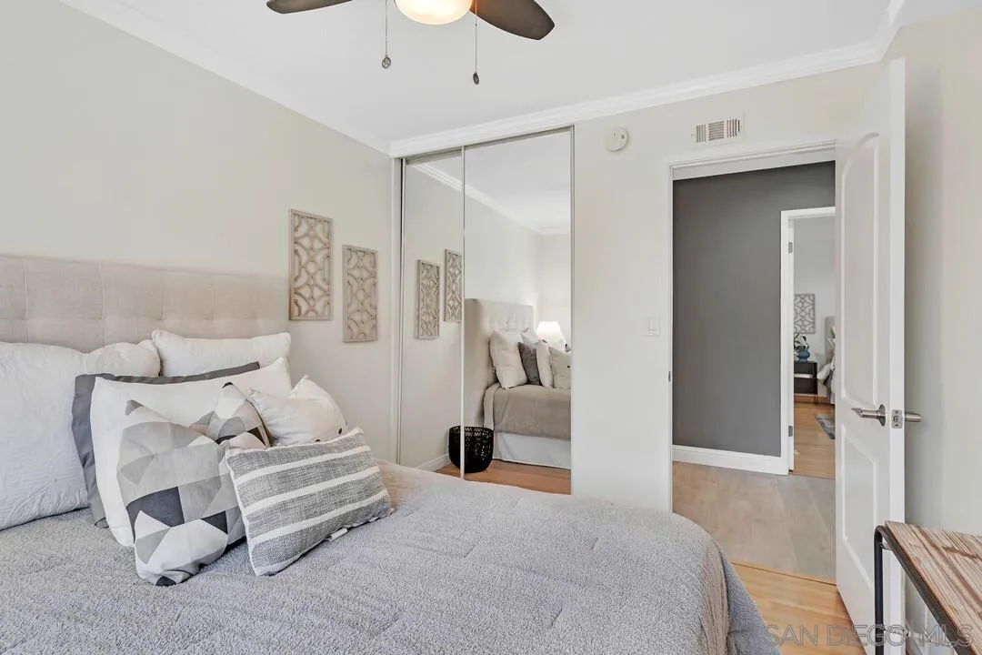 11021 Sagittarius Road San Diego, CA 92126 - Photo 20 of 28 a bedroom with a bed and a night stand