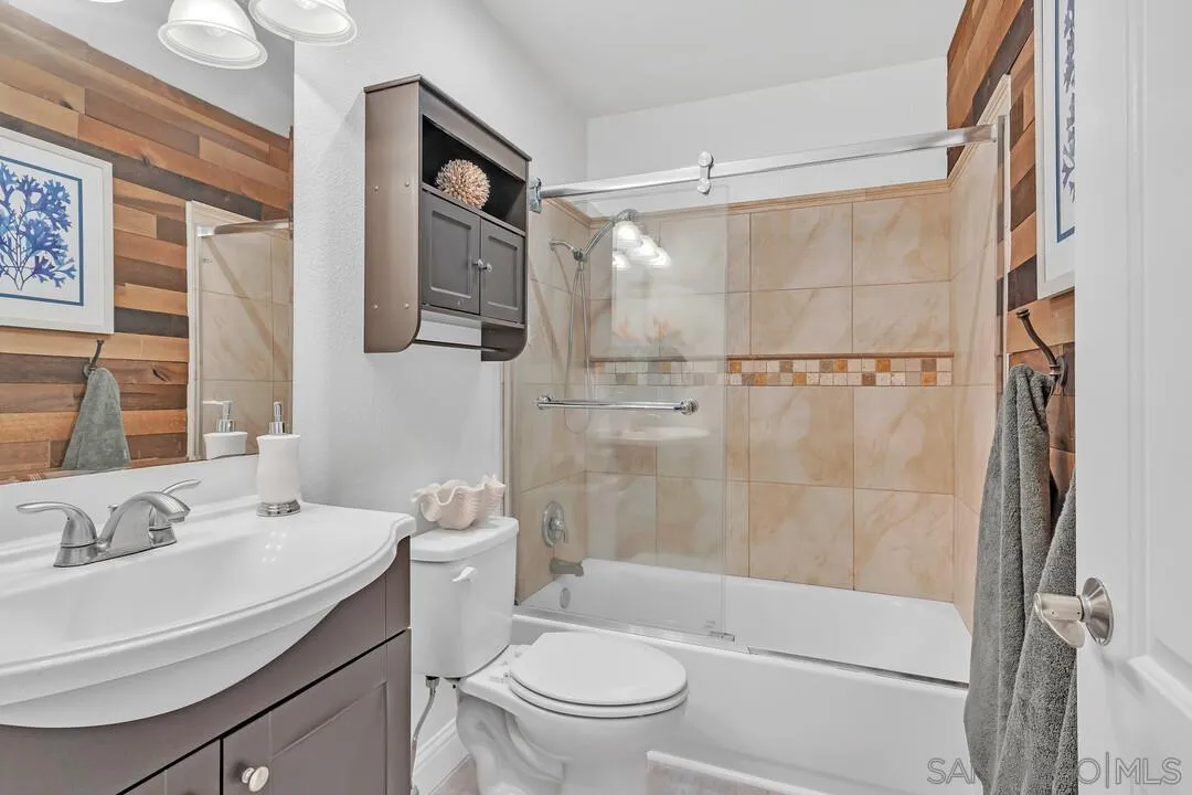 11021 Sagittarius Road San Diego, CA 92126 - Photo 21 of 28 a bathroom with a sink toilet and shower