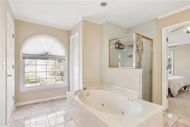 a bathroom with a bathtub and a window