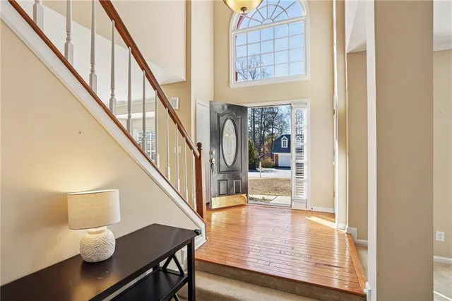 a view of entryway and hall with wooden floor