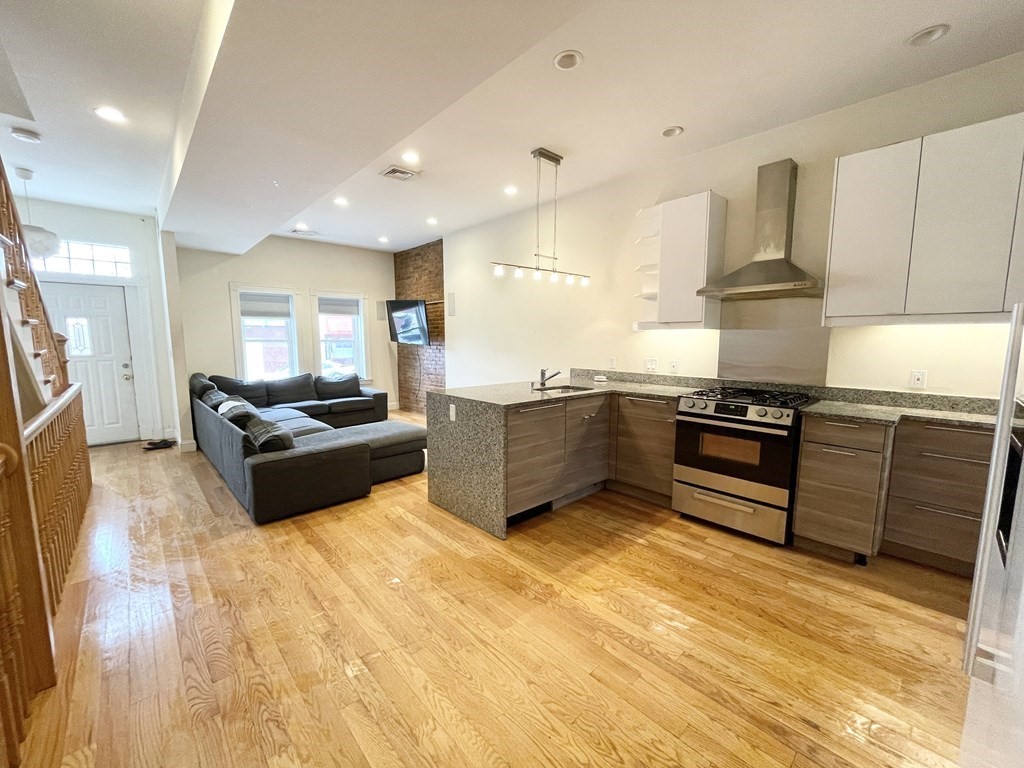 98 L Street, Unit STREET Boston, MA 02127 - Photo 2 of 19 a kitchen with stainless steel appliances granite countertop a stove and a sink