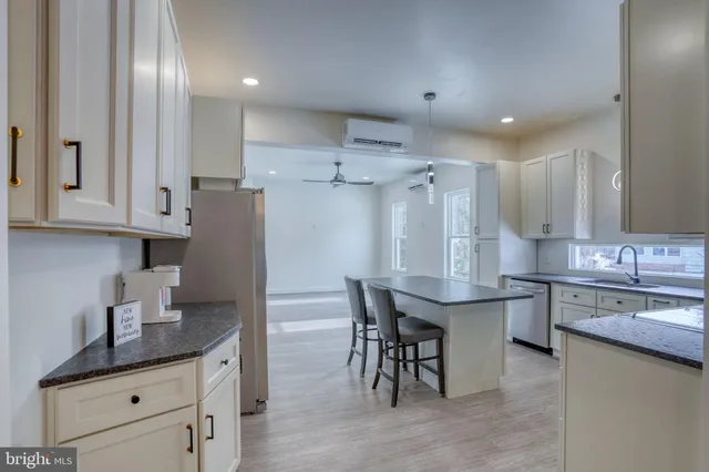 a kitchen with stainless steel appliances granite countertop a sink stove and cabinets