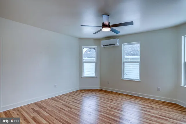 a bathroom with a bathtub sink vanity and mirror