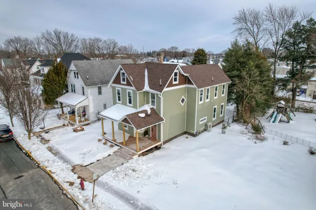 an aerial view of a house with a yard basket ball court and outdoor seating