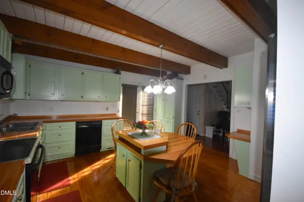 a kitchen with a table and chairs in it