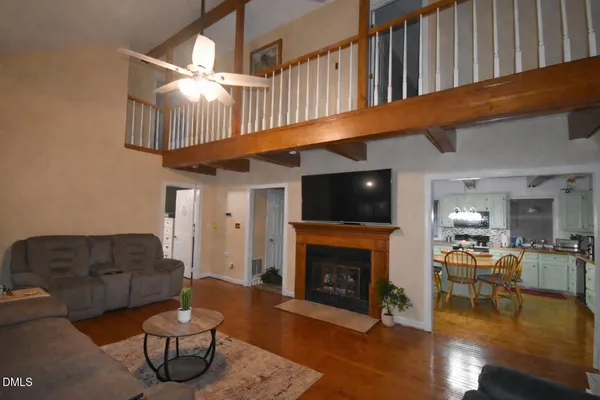 a living room with furniture a pool table and a fireplace