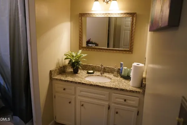 a bed sitting in a bedroom and a mirror