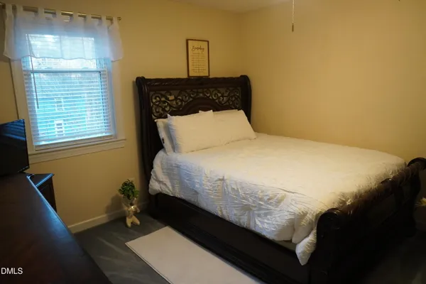 a bedroom with a bed and mirror