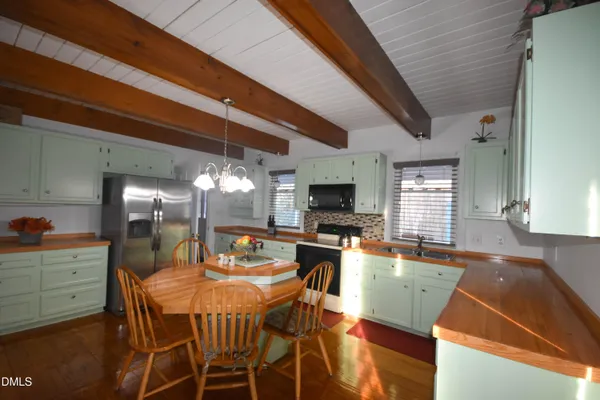 a view of a dining room with furniture and a flat screen tv
