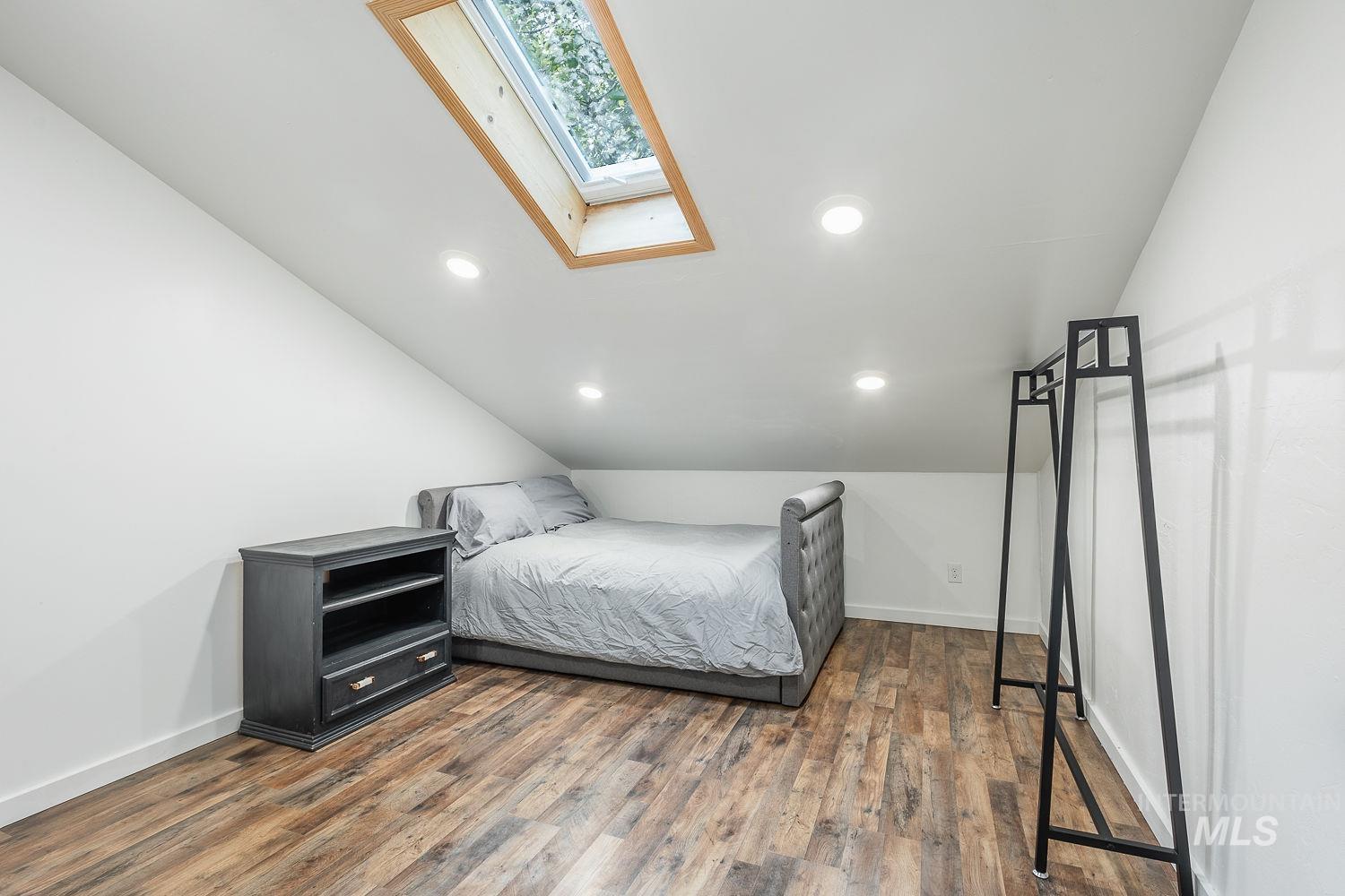 7166 South Cloverdale Road Boise, ID 83709 - Photo 35 of 50 Wood-finish flooring with white baseboards and sloped ceilings