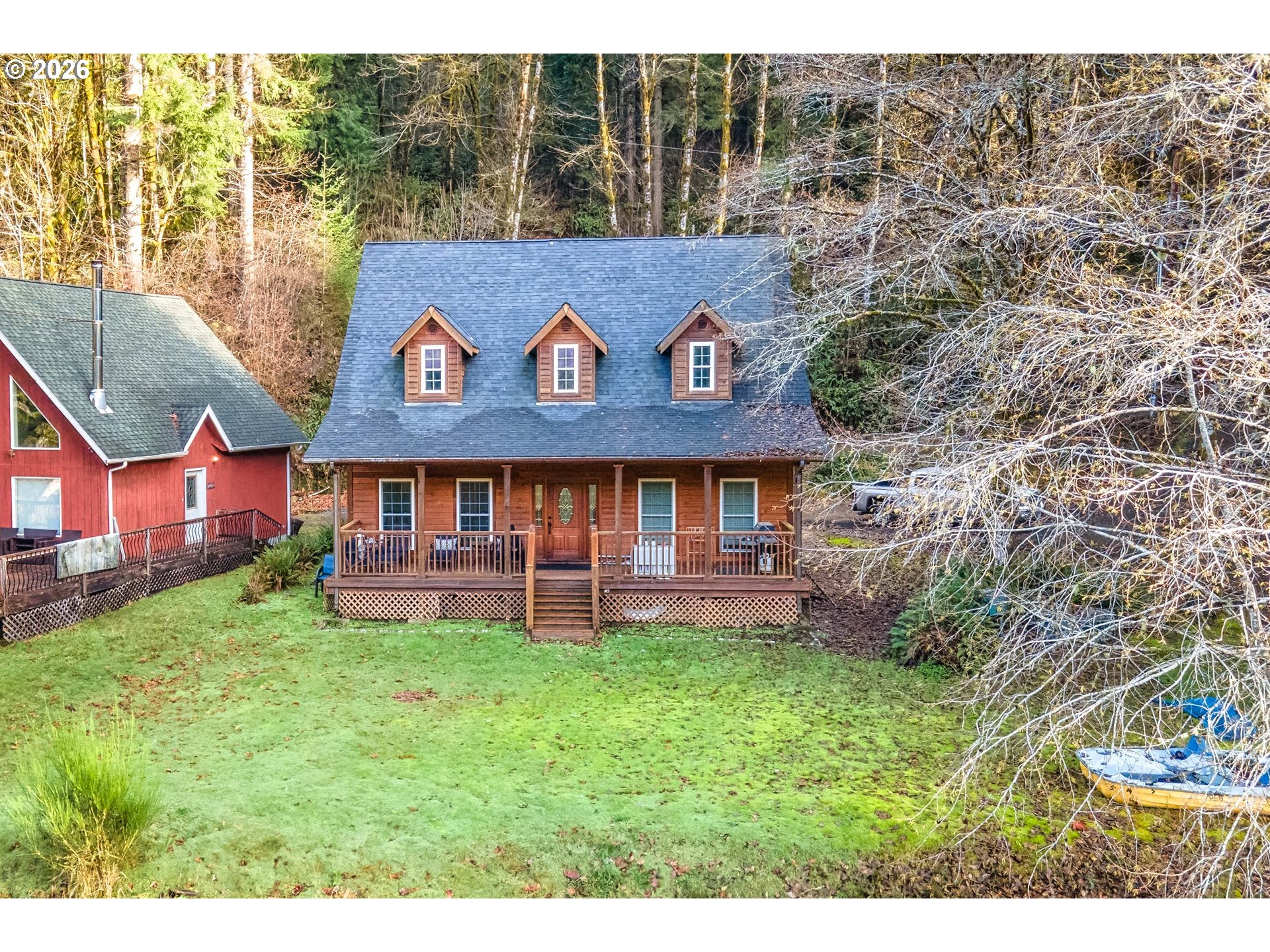 71381 Fishhawk Road Birkenfeld, OR 97016 - Photo 1 of 26 a view of a house with a yard and sitting area
