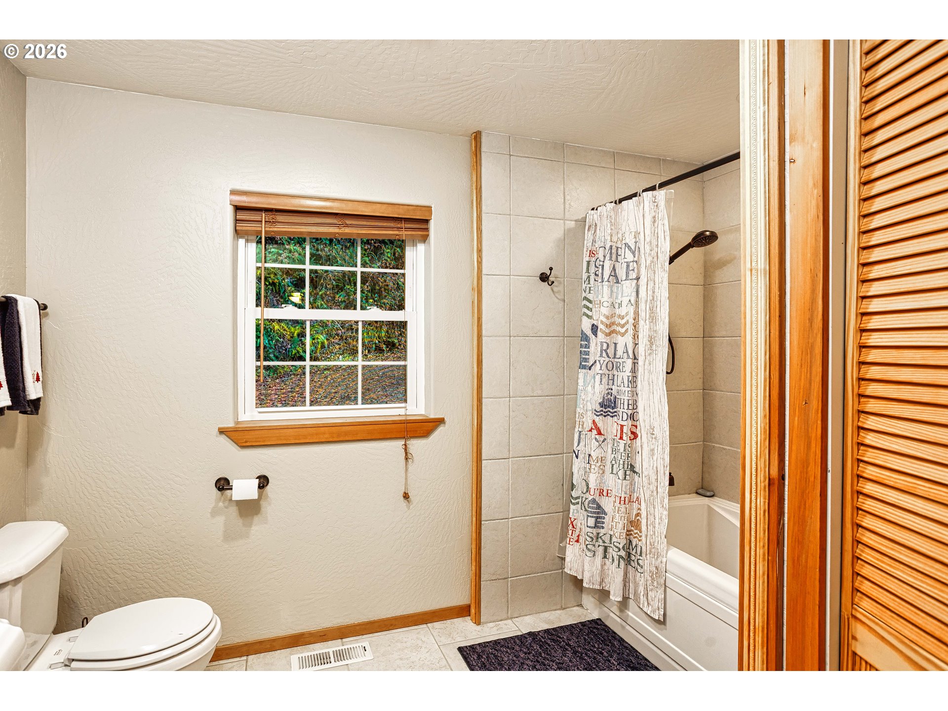 71381 Fishhawk Road Birkenfeld, OR 97016 - Photo 11 of 26 a bathroom with a window a sink and a shower