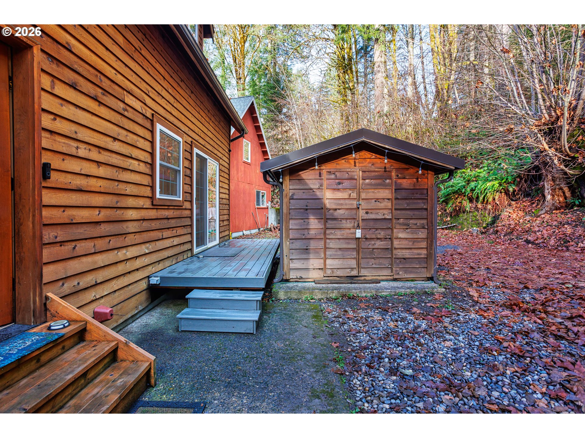 71381 Fishhawk Road Birkenfeld, OR 97016 - Photo 19 of 26 a backyard of a house with wooden fence and large trees