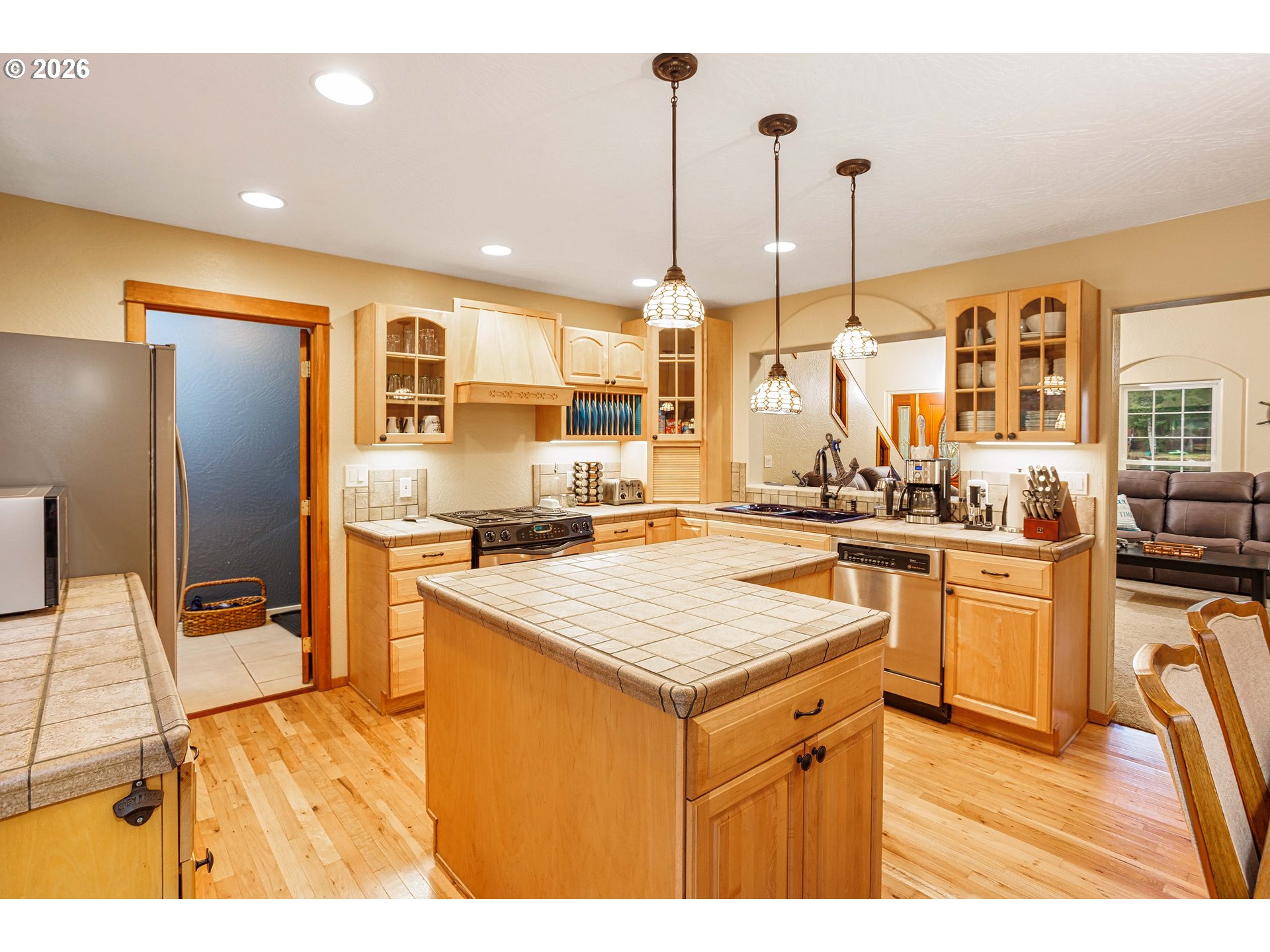 71381 Fishhawk Road Birkenfeld, OR 97016 - Photo 7 of 26 a kitchen with stainless steel appliances kitchen island granite countertop a stove a sink dishwasher and a refrigerator
