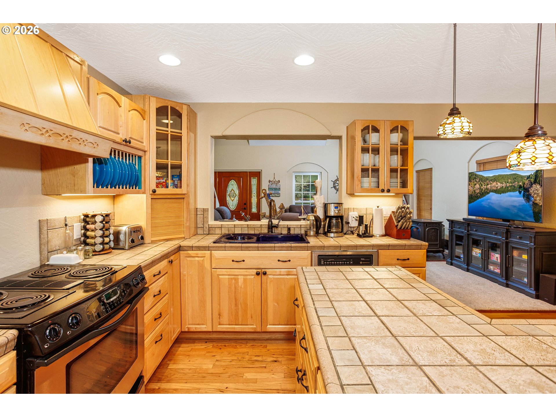 71381 Fishhawk Road Birkenfeld, OR 97016 - Photo 8 of 26 a kitchen with stainless steel appliances granite countertop a stove a sink and a microwave