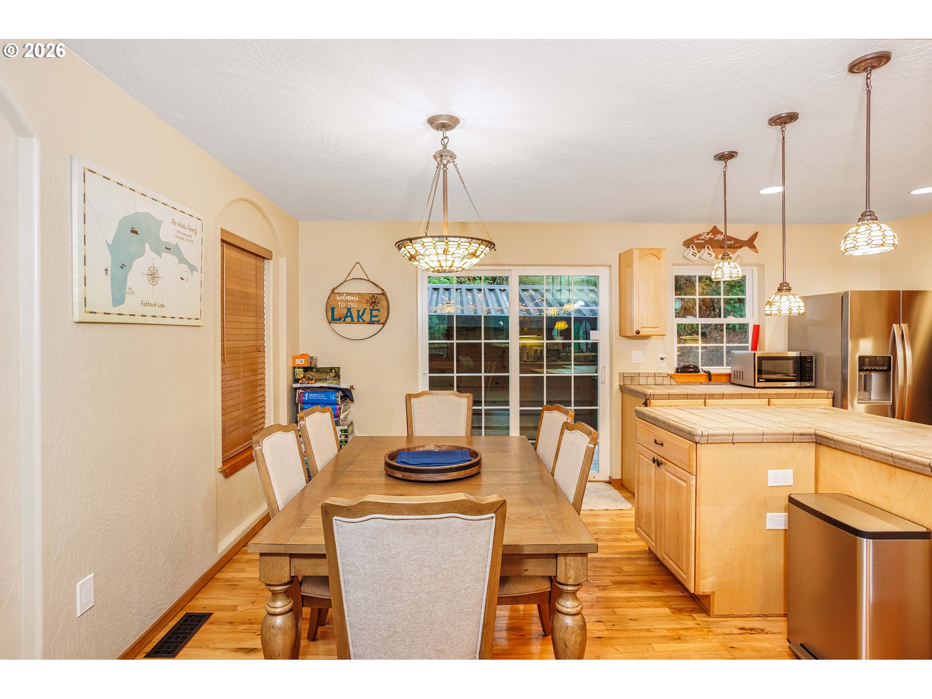 71381 Fishhawk Road Birkenfeld, OR 97016 - Photo 9 of 26 a living room with furniture a flat screen tv and a chandelier