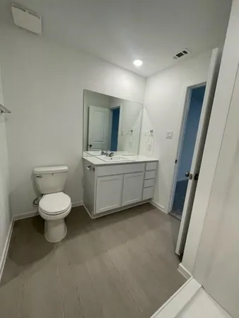 a bathroom with a toilet a sink and a mirror