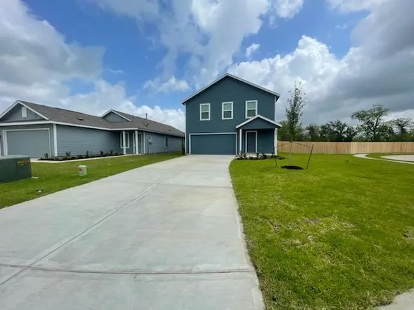 a front view of a house with yard and green space