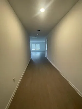 an empty room with a empty space and windows