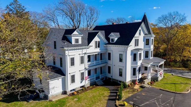 a view of residential houses with yard and trees