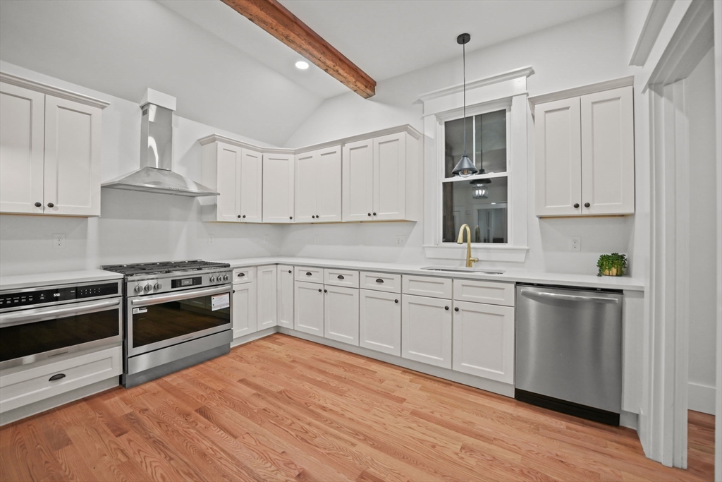 16 Water Street, Unit B Freetown, MA 02702 - Photo 4 of 22 a kitchen with stainless steel appliances granite countertop a stove and white cabinets