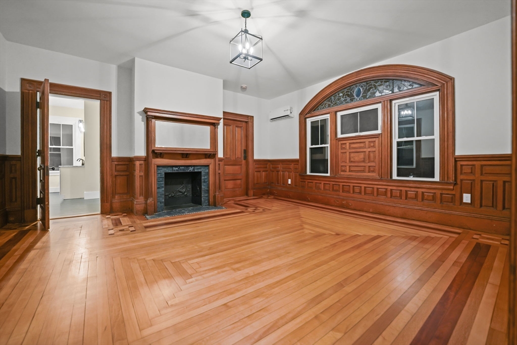 16 Water Street, Unit B Freetown, MA 02702 - Photo 9 of 22 a view of an empty room with wooden floor fireplace and a window