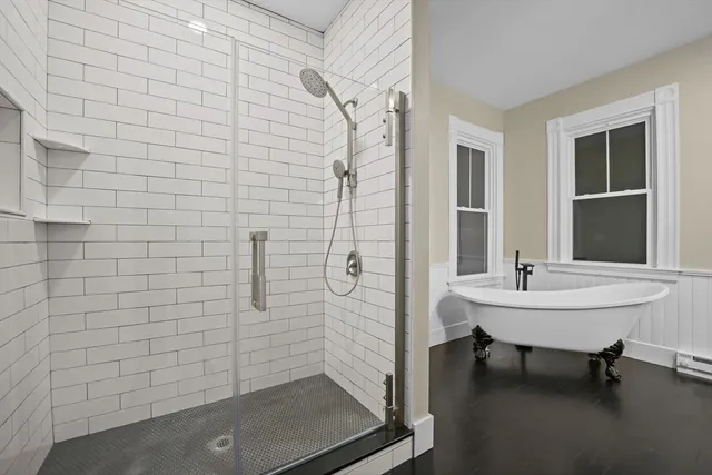 a bathroom with a sink shower and a mirror