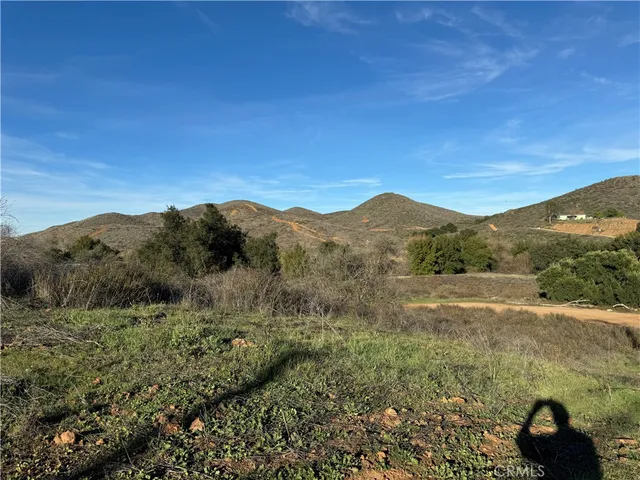 a view of a large mountain with mountains in the background